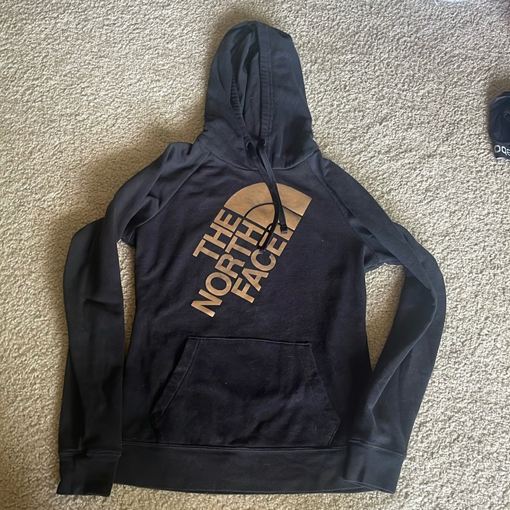The North Face black and shiny gold metallic graphic logo pullover hoodie small
